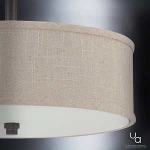 Close-up of the Urban Ambiance UQL2231 Modern Farmhouse Semi-Flush Ceiling Light from the Dublin Collection, featuring a khaki fabric drum shade and a bronze-finished fixture, illuminated against a gradient gray background.