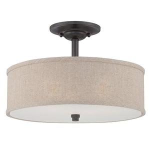 The Urban Ambiance UQL2231 Modern Farmhouse Semi-Flush Ceiling Light from the Dublin Collection features a 12-inch high by 17-inch wide design with a round khaki fabric drum shade and elegant bronze-finished hardware for a stylish farmhouse look.