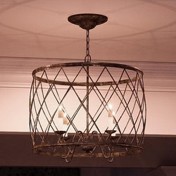 A unique Urban Ambiance UQL2261 French Country Chandelier, 20"H x 23"W, Silver Leaf Finish, from the York Collection hanging over a dining room table.
