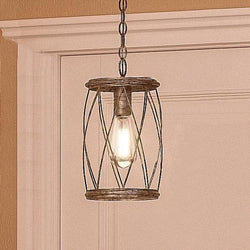 A beautiful and unique UQL2264 French Country pendant light is hanging from a doorway.