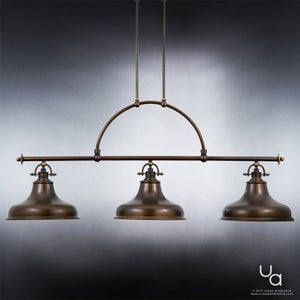 Three industrial-style pendant lights from the Urban Ambiance UQL2285 Industrial Chandelier, part of the Sonoma Collection, hang from a horizontal rod supported by two vertical rods against a neutral gradient background. The fixture measures 23.5″ high by 52.5″ wide and features refined industrial-inspired detailing with an elegant Parisian Bronze finish, reminiscent of the iconic Sonoma chandelier.