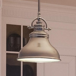 An Urban Ambiance pendant light hanging over a kitchen counter, specifically the UQL2289 Industrial Hanging Pendant Light from their Sonoma Collection, measuring 9"H x 8"W and featuring a brushed