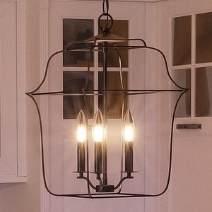 An Urban Ambiance Colonial Chandelier, 14.75"H x 10"W, Vintage Black Finish, Savannah Collection luxury lighting fixture hanging over a kitchen counter.