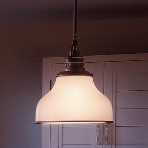 An Urban Ambiance pendant lamp hanging over a kitchen counter - unique lighting fixture.