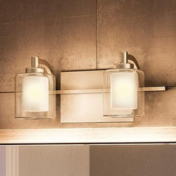 An Urban Ambiance bathroom vanity with two UQL2400 Modern Bathroom Vanity Lights from the Napa Collection and a mirror, adding a touch of luxury.