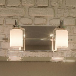 A gorgeous Urban Ambiance bathroom vanity with two UQL2401 Modern Bathroom Vanity Lights for beautiful lighting, Polished Chrome Finish from the Napa Collection, and a brick wall.