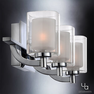 The Urban Ambiance UQL2402 Modern Bathroom Vanity Light from the Napa Collection features three frosted glass shades mounted on a curved metal base with a polished chrome finish, measuring 6 inches high by 21 inches wide, displayed against a gradient background.