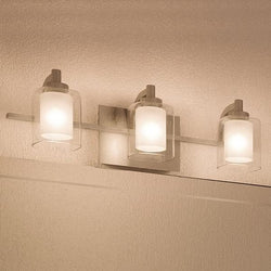 Three unique UQL2403 luxury bathroom vanity lights, 6"H x 21"W, brushed nickel finish, Napa Collection from the brand Urban Ambiance hanging on a wall in a
