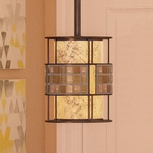 The UQL2433 Art Deco Hanging Pendant Light from the Genoa Collection by Urban Ambiance features a sleek metal frame and textured glass panels in a Copper Revival finish, beautifully showcased against a beige wall adorned with abstract art.