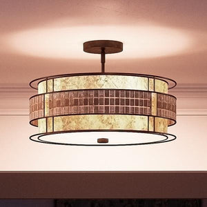 The UQL2435 Art Deco Semi-Flush Ceiling Light from the Genoa Collection by Urban Ambiance features a layered drum design and a rich Copper Revival finish, casting warm, diffused light on the ceiling and surrounding area to enhance an elegant ambiance.