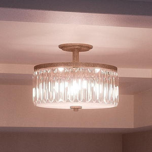 An Urban Ambiance UQL2520 Crystal Ceiling Light, a beautiful and unique lighting fixture with an Antique Gold Finish, from the Austin Collection in a room with a glass shade.