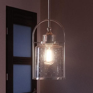 A luxury lighting fixture with a gorgeous glass shade hanging over a door.