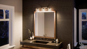 A modern bathroom featuring a dark countertop, double sink, large mirror with a wooden frame, and decorative items on the counter is beautifully illuminated by the Urban Ambiance UQL2722 Modern Bathroom Light from the San Diego Collection, showcasing wavy glass shades and a sleek brushed nickel finish.