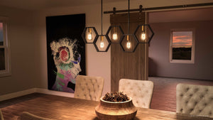 A dining room with a beautiful Urban Ambiance UQL2771 Industrial Chandelier hanging over a table.