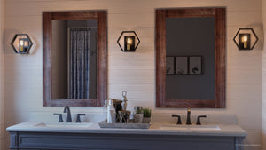 A beautiful bathroom with two Urban Ambiance UQL2773 Industrial Wall Sconces, featuring a luxurious Natural Black Finish, Venezia Collection, and complemented by two mirrors.