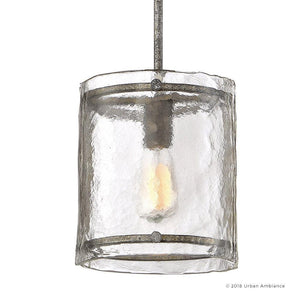 The Urban Ambiance UQL2871 Industrial Pendant from the Nantes Collection, featuring a 10-inch high by 9.25-inch wide cylindrical water-glass shade with a silver etch finish and metal accents, hangs from a rod against a white background—showcasing an industrial pendant light style ideal for rustic kitchen lighting.