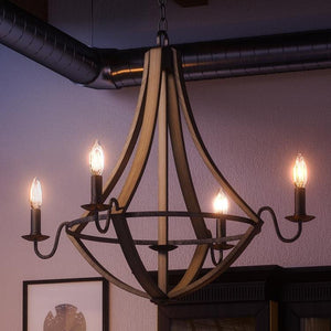 A beautiful Farmhouse Chandelier with a unique Wood Grain Metal design from the Swansea Collection is hanging in a dining room.