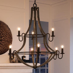A gorgeous lighting fixture, the UQL2961 Farmhouse Chandelier from the Swansea Collection by Urban Ambiance, adds luxury to any living room with its wood grain metal and antique black finish.