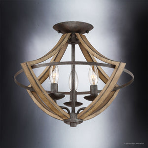 The Urban Ambiance Swansea Collection UQL2963 Farmhouse Ceiling Light (12.5″H x 16.5″W) showcases three exposed bulbs, a round mount, and gracefully curved metal with an antique black finish complemented by wood grain accents—captured here against a gradient gray background.