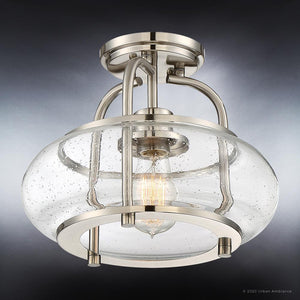 Close-up of the Urban Ambiance UQL3280 Utilitarian Ceiling Light from the Clearwater Collection, featuring a modern brushed nickel finish and a clear, seeded glass shade that showcases an exposed bulb—an elegant example of a seeded glass flush mount fixture measuring 10″ high by 12″ wide.