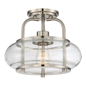 The Urban Ambiance UQL3280 Utilitarian Ceiling Light from the Clearwater Collection features a modern brushed nickel finish, clear seeded glass shade with exposed bulb, and a round base, making it a stylish 10″ x 12″ flush mount perfect for contemporary interiors.