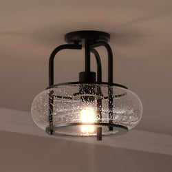 A beautiful Urban Ambiance black ceiling light with a glass shade from the Clearwater Collection.
