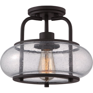 The UQL3281 Utilitarian Ceiling Light by Urban Ambiance, from the Clearwater Collection, showcases a dark bronze finish with an oversized clear seedy glass shade and visible Edison bulb, merging vintage charm with modern design. Dimensions: 10