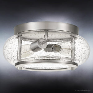 The Urban Ambiance UQL3290 Utilitarian Ceiling Light from the Clearwater Collection features a brushed nickel finish and two exposed bulbs, enclosed in a clear seeded glass shade with a bubble pattern. Measuring 5.75″ high by 12″ wide and set against a gradient gray background, it’s the perfect modern farmhouse ceiling light.