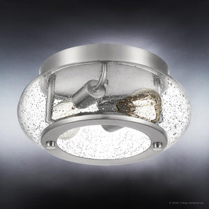 The Urban Ambiance UQL3290 Utilitarian Ceiling Light from the Clearwater Collection features a brushed nickel finish and a clear, seeded glass shade with two exposed bulbs. Measuring 5.75 inches high by 12 inches wide, this modern farmhouse fixture adds a stylish, contemporary touch to any space.