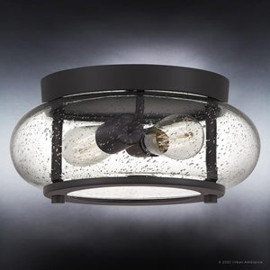 Close-up of the UQL3291 Utilitarian Ceiling Light by Urban Ambiance from the Clearwater Collection, featuring seedy glass shades and two vintage-inspired bulbs, with a round design and dark bronze finish, measuring 5.75