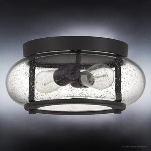 The UQL3291 Utilitarian Ceiling Light from Urban Ambiance's Clearwater Collection features a dark bronze frame and seedy glass shade that houses two vintage-inspired bulbs, measuring 5.75