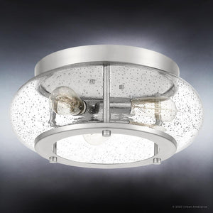 Elevate your space with the UQL3300 Utilitarian Ceiling Light from Urban Ambiance’s Clearwater Collection, shown here in a brushed nickel finish. Measuring 7″H x 16″W, this modern farmhouse flush mount features a sleek metal frame and seeded glass shade housing two exposed bulbs, creating contemporary elegance against a dark gradient background.