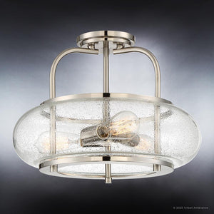 The Urban Ambiance UQL3310 Utilitarian Ceiling Light from the Clearwater Collection features a brushed nickel finish, clear textured glass shade, and two exposed bulbs. Set against a dark gradient background, this modern semi-flush ceiling light blends sleek metal with airy style in a 12-inch high by 16-inch wide design—perfect for brightening any space.