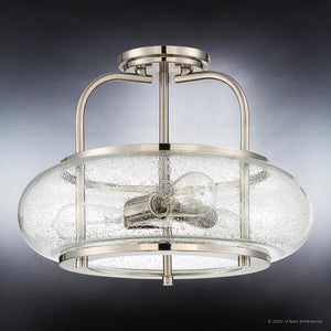 The Urban Ambiance UQL3310 Utilitarian Ceiling Light from the Clearwater Collection showcases a brushed nickel finish with a sleek metal frame and a round, clear textured glass shade. Measuring 12″ high by 16″ wide, this fixture houses two exposed bulbs for an elegant, modern look. Its seeded glass design adds visual interest while delivering bright illumination to any space.