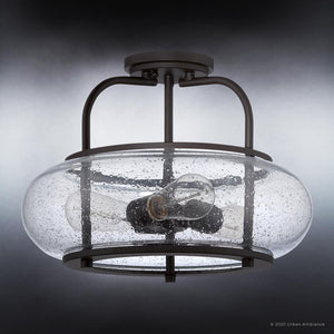 The UQL3311 Utilitarian Ceiling Light by Urban Ambiance features a clear seedy glass shade and vintage bulb on a dark bronze fixture. As part of the Clearwater collection, it blends modern design with timeless elegance against a gradient gray background. Dimensions: 12