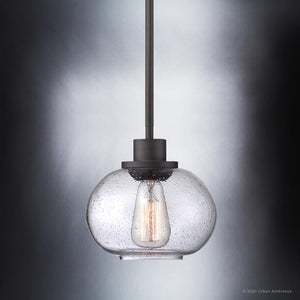 From the Clearwater Collection by Urban Ambiance, the UQL3321 Utilitarian Pendant Light features a round clear glass shade and vintage-style bulb, elegantly suspended from a dark bronze rod.