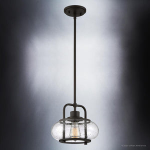 The Urban Ambiance UQL3331 Utilitarian Pendant Light from the Clearwater Collection features a dark bronze finish, oversized clear seedy glass shade, and nautical aesthetics, in a 9.5