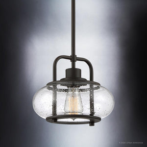 Explore Urban Ambiance's UQL3331 Utilitarian Pendant Light from the Clearwater Collection, featuring a dark bronze finish and an oversized clear seedy glass shade that reveals an exposed bulb, perfect for adding nautical charm to any room.
