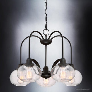 From Urban Ambiance's Clearwater collection, the UQL3361 Utilitarian Chandelier features a dark bronze finish with eight clear glass globe lamps, each showcasing vintage-inspired bulbs, suspended from a chain against a gradient gray background. Dimensions: 19