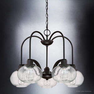 The UQL3361 Utilitarian Chandelier by Urban Ambiance, from the Clearwater Collection, showcases six vintage-style bulbs within speckled glass globes against a gradient background, in a dark bronze finish. Dimensions: 19