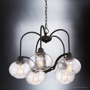 Introducing the UQL3361 Utilitarian Chandelier from Urban Ambiance's Clearwater Collection. This elegant piece features a Dark Bronze finish, five clear seedy glass shades, and vintage-inspired bulbs. Perfectly blending modern design with classic charm, it hangs gracefully from a chain.