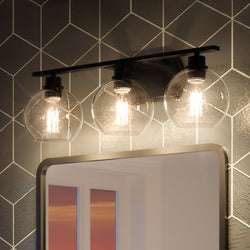 A bathroom with a UQL3453 Utilitarian Bath Vanity Light, 8.5"H x 26.25"W from the Waterbury Collection in Matte Black Finish by Urban Ambiance, providing