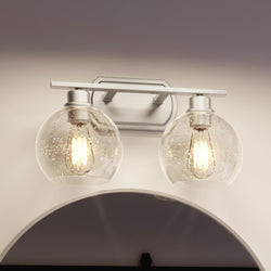 A unique lighting fixture with two UQL3454 Utilitarian Bath Vanity Light, 8.5"H x 16.5"W, Brushed Nickel Finish, Waterbury Collection glass glob