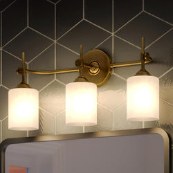 A beautiful bathroom with three UQL3491 Mid-Century Modern Bath Vanity Lights, 10"H x 22.5"W, Rustic Brass Finish from the Rialto Collection by Urban