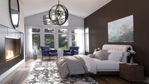 Modern bedroom with dark accent wall, tufted bed, patterned rug, fireplace, two blue armchairs by large windows, and an Urban Ambiance Abilene UQL3110 XL Urban Loft Chandelier in weathered black overhead.