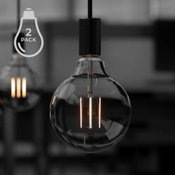 A black and white photo of two luxury LED Bulbs by Urban Ambiance hanging in a room.
