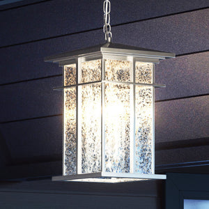 A high-end Craftsman Outdoor Pendant 14''H x 9''W, Burnished Aluminum Finish, Milwaukee Collection light fixture hanging from the ceiling of a house.