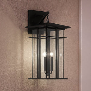 A unique UEX1007 Craftsman Outdoor Wall Sconce 22''H x 9''W, with a beautiful Matte Black Finish, hanging on a wall from the Milwaukee Collection.