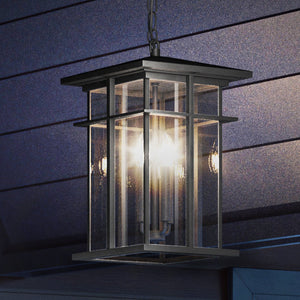 An UEX1010 Craftsman Outdoor Pendant 14''H x 9''W, Matte Black Finish lamp hanging from the side of a house.