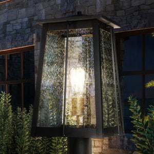 A beautiful Craftsman outdoor post light featuring a luxury matte black & native brass finish from the Athens Collection, complete with a light bulb.